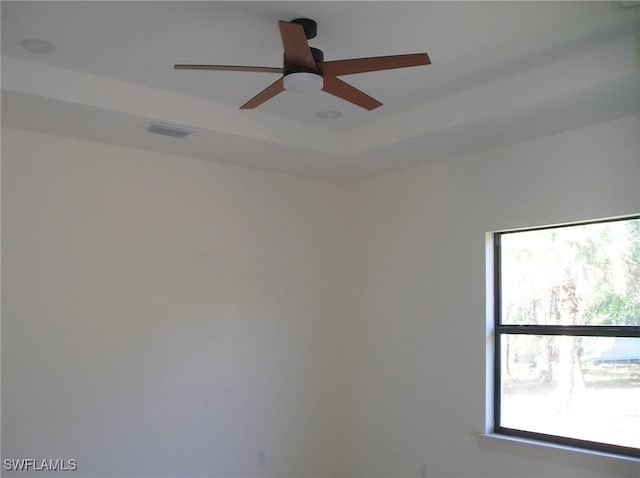 empty room featuring ceiling fan and visible vents