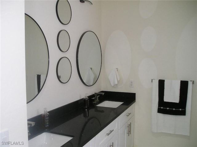 bathroom featuring a sink and double vanity