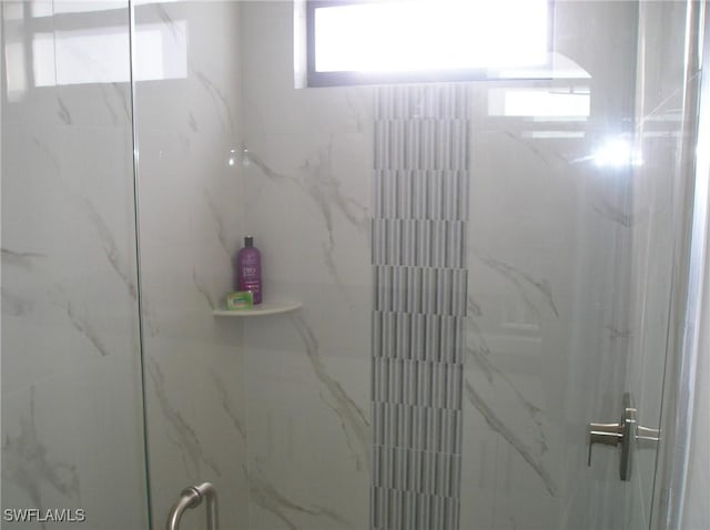 full bath with a marble finish shower