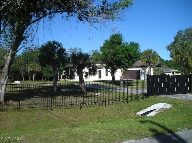 view of community featuring a lawn and fence