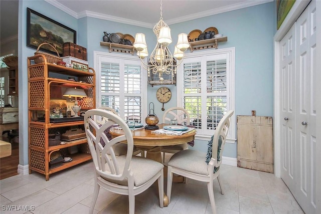 dining area with a chandelier, ornamental molding, light tile patterned flooring, and baseboards