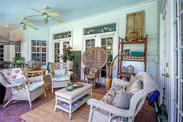 sunroom / solarium featuring ceiling fan