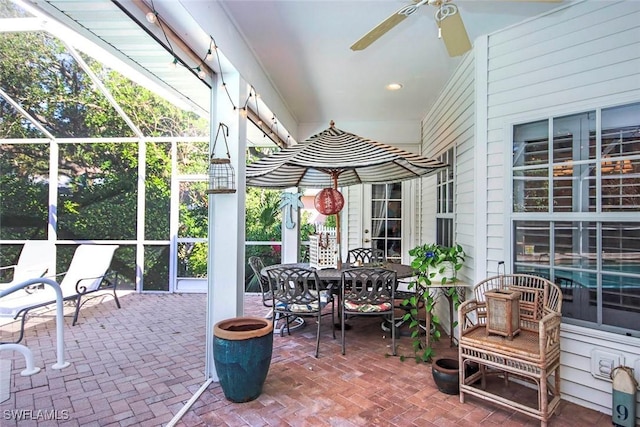 sunroom / solarium featuring a ceiling fan