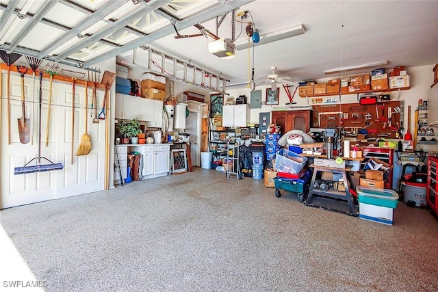 garage with a garage door opener, a ceiling fan, and a workshop area