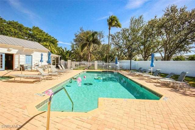 pool featuring a patio area and fence