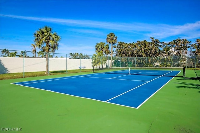 view of sport court featuring fence