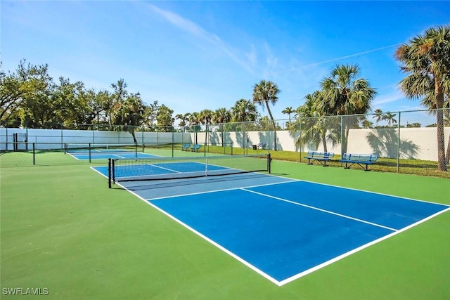 view of sport court featuring fence