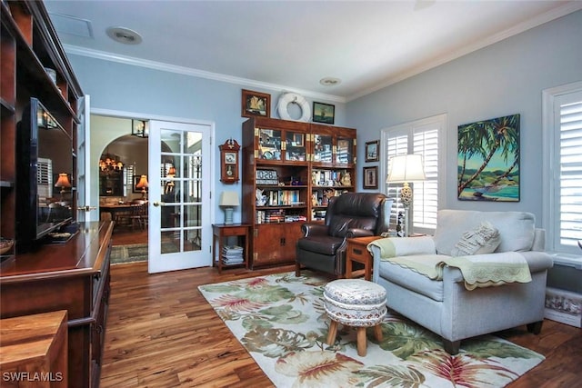 living area with arched walkways, french doors, dark wood-style floors, and ornamental molding