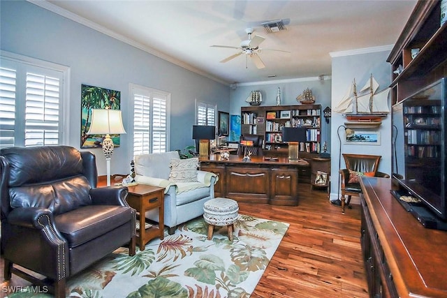 interior space featuring dark wood-style flooring, ceiling fan, visible vents, and crown molding