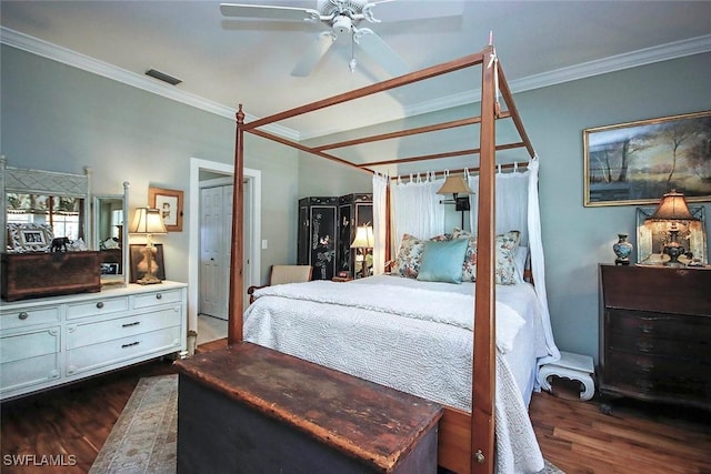 bedroom featuring visible vents, dark wood-type flooring, and ornamental molding