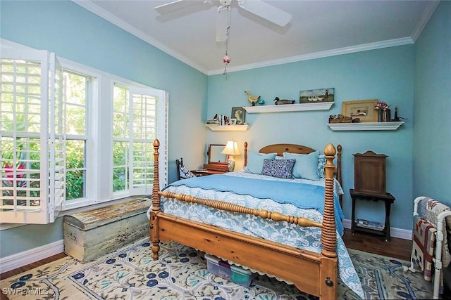 bedroom featuring a ceiling fan, crown molding, baseboards, and wood finished floors