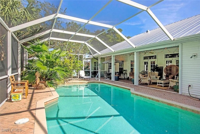 pool featuring ceiling fan, a patio, outdoor lounge area, and a lanai