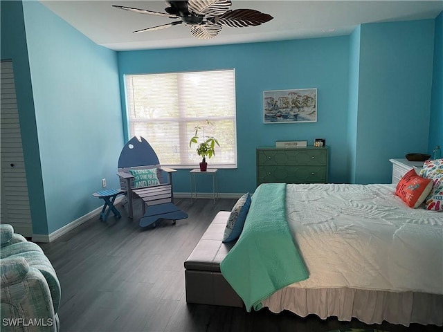 bedroom with ceiling fan, baseboards, and wood finished floors