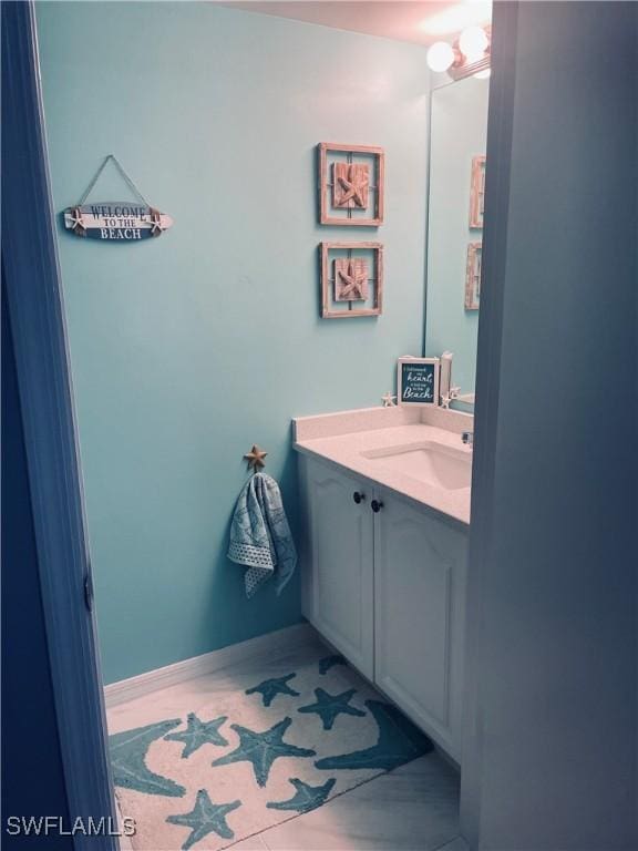 bathroom with baseboards and vanity