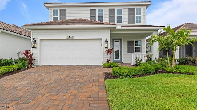 4568 Centaurus Cir, Naples, FL 34120 - traditional home with a porch, decorative driveway, a garage, and a front lawn