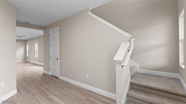 4568 Centaurus Cir, Naples, FL 34120 - stairway featuring baseboards and wood finished floors