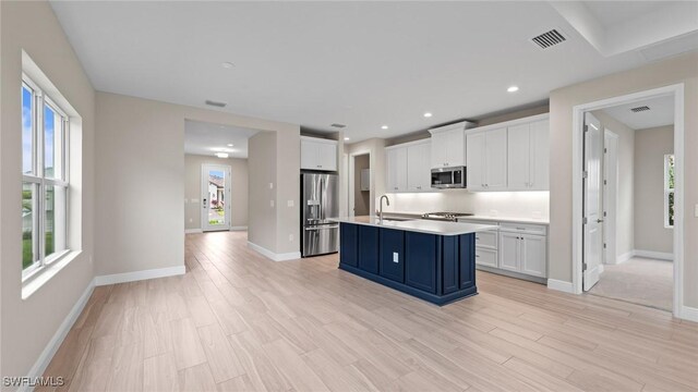 4568 Centaurus Cir, Naples, FL 34120 - kitchen with appliances with stainless steel finishes, a sink, white cabinetry, plenty of natural light, and recessed lighting