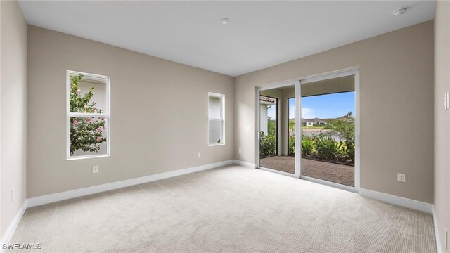 4568 Centaurus Cir, Naples, FL 34120 - spare room featuring carpet flooring, baseboards, and a smoke detector