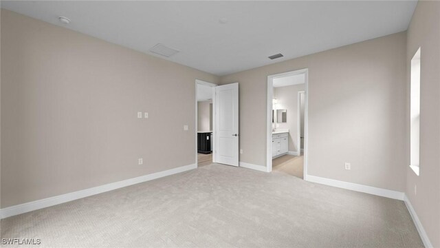 4568 Centaurus Cir, Naples, FL 34120 - unfurnished bedroom featuring light carpet, baseboards, and ensuite bathroom