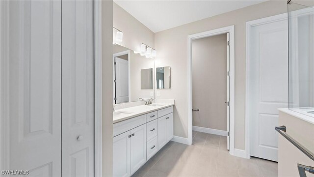 4568 Centaurus Cir, Naples, FL 34120 - bathroom with double vanity, baseboards, and tile patterned flooring