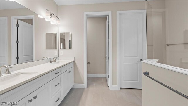 4568 Centaurus Cir, Naples, FL 34120 - full bath with double vanity, tile patterned flooring, and baseboards