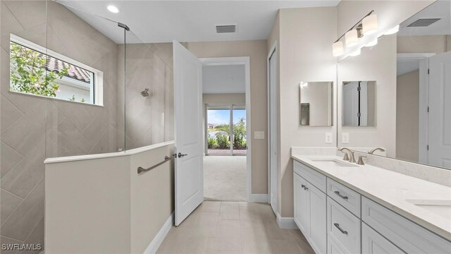 4568 Centaurus Cir, Naples, FL 34120 - full bathroom featuring double vanity, a walk in shower, and baseboards