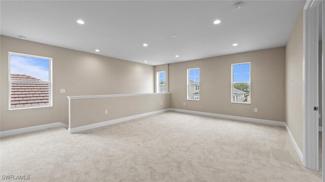 4568 Centaurus Cir, Naples, FL 34120 - empty room featuring light colored carpet, plenty of natural light, baseboards, and recessed lighting