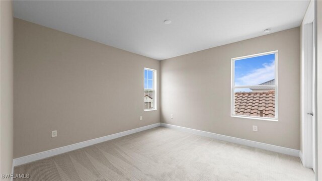 4568 Centaurus Cir, Naples, FL 34120 - spare room featuring light carpet, baseboards, and a smoke detector