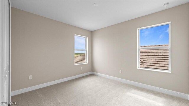 4568 Centaurus Cir, Naples, FL 34120 - empty room featuring light colored carpet, baseboards, and a smoke detector