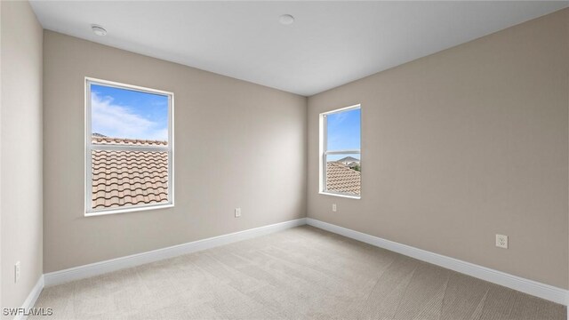 4568 Centaurus Cir, Naples, FL 34120 - carpeted empty room with baseboards and a smoke detector