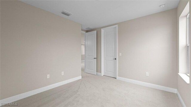 4568 Centaurus Cir, Naples, FL 34120 - empty room with light carpet and baseboards