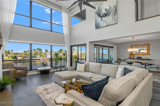 living area featuring ceiling fan with notable chandelier