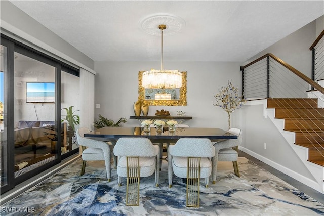 dining area featuring stairs and baseboards