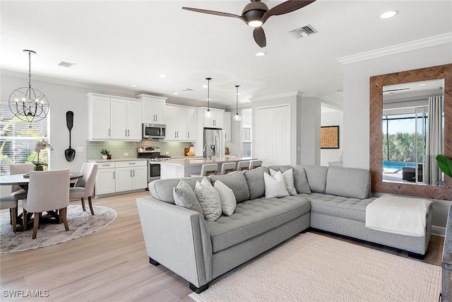 living area with recessed lighting, visible vents, crown molding, and light wood finished floors