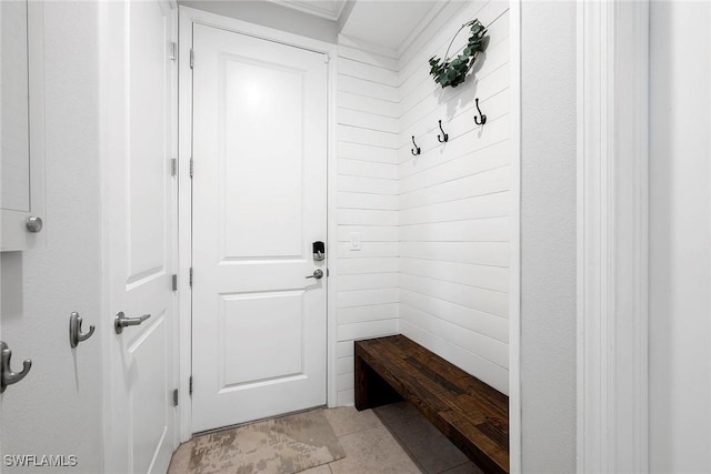 mudroom featuring wood walls and light tile patterned flooring