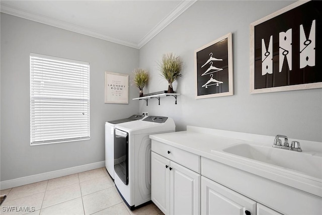 washroom featuring light tile patterned floors, washing machine and dryer, baseboards, cabinet space, and crown molding