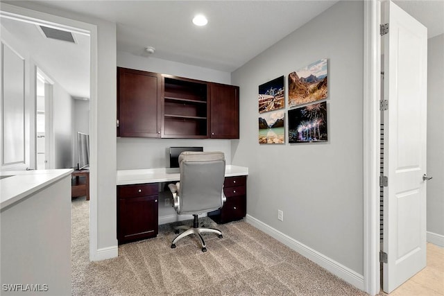 office area with light colored carpet, visible vents, and baseboards