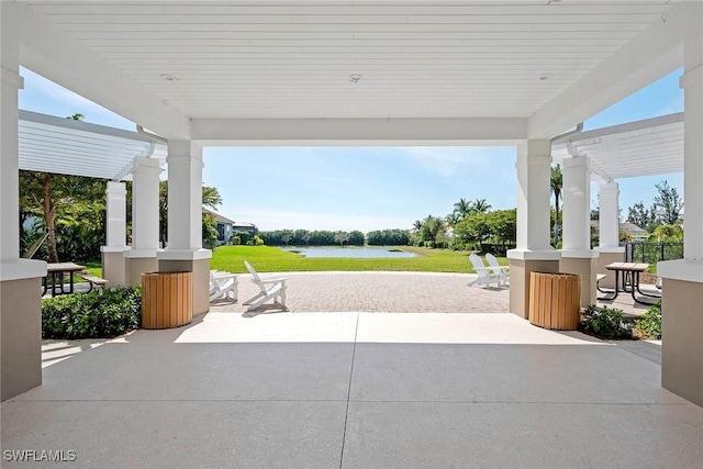 view of patio / terrace with a water view and a pergola