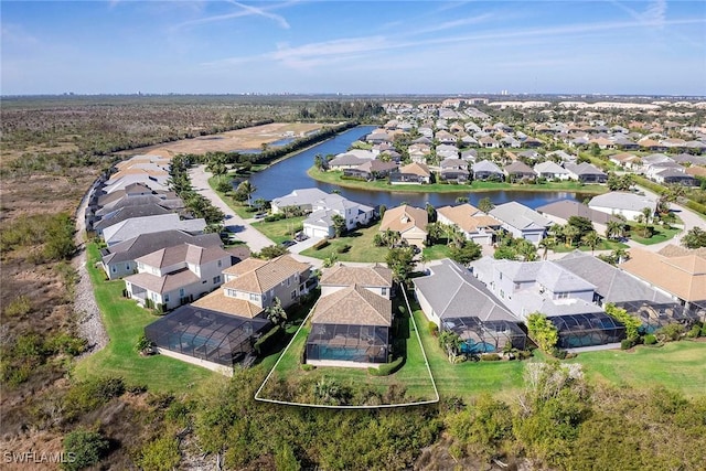 bird's eye view featuring a water view and a residential view