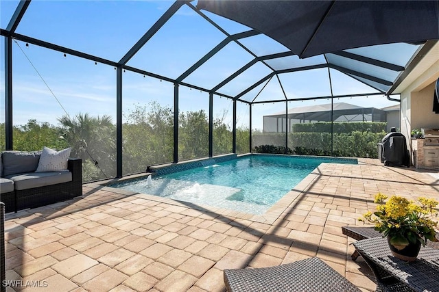 outdoor pool featuring a patio area, glass enclosure, and an outdoor living space