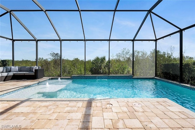 pool featuring a lanai, a patio, and an outdoor hangout area