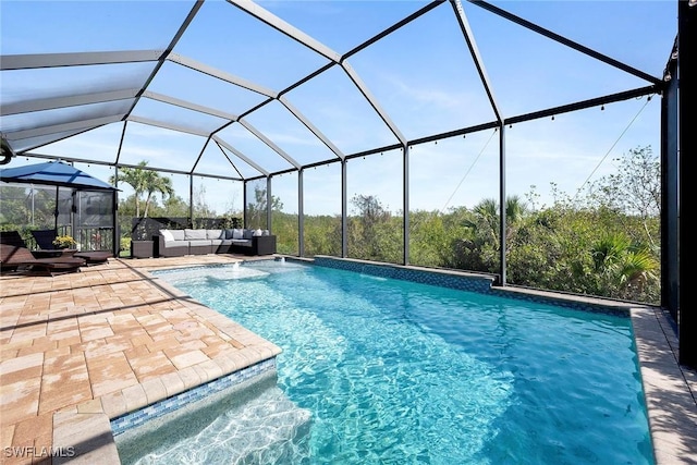 outdoor pool featuring glass enclosure, a patio, and an outdoor living space