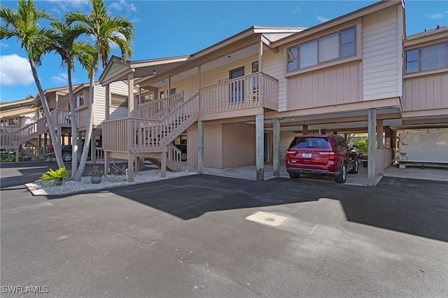 7629 Captains Harbor Dr Unit 1203, Bokeelia, FL 33922 - view of building exterior featuring covered parking and stairs