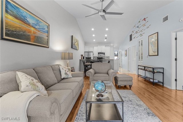 7629 Captains Harbor Dr Unit 1203, Bokeelia, FL 33922 - living room featuring high vaulted ceiling, wood finished floors, visible vents, and a ceiling fan