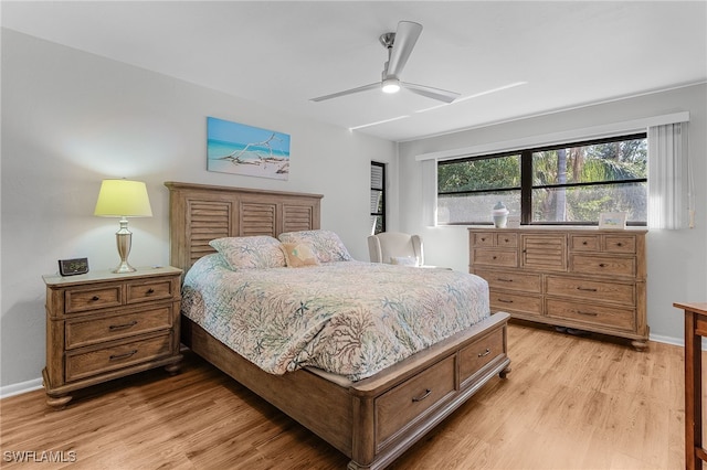 7629 Captains Harbor Dr Unit 1203, Bokeelia, FL 33922 - bedroom featuring light wood-type flooring, baseboards, and a ceiling fan