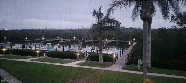 7629 Captains Harbor Dr Unit 1203, Bokeelia, FL 33922 - view of property's community featuring a dock, a water view, and a lawn