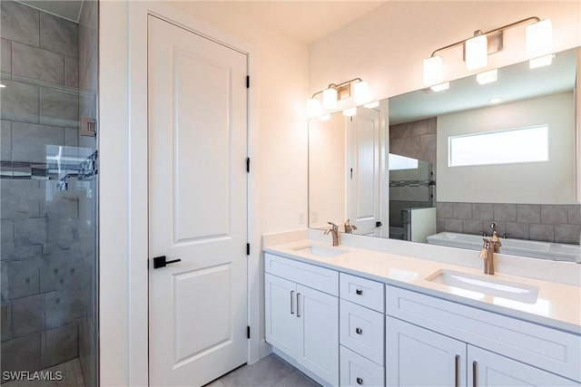 full bathroom featuring a garden tub, double vanity, a sink, and a shower stall