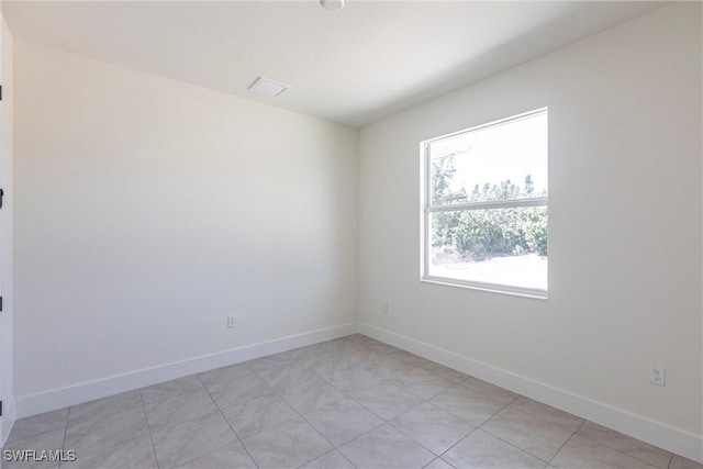 unfurnished room featuring baseboards