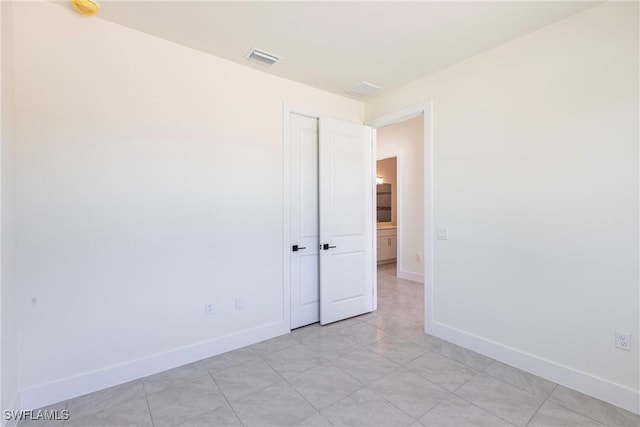 empty room featuring visible vents and baseboards