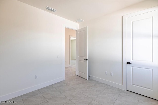 unfurnished bedroom featuring visible vents and baseboards